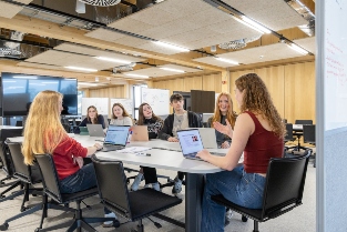 A group of students sat at a table discussing work